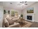 A cozy living room is staged with furniture, fireplace, and large window at 464 Meadowbrook Dr, Mcdonough, GA 30253