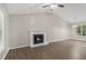 The cozy living room has wood-look floors, a fireplace, and abundant natural light at 464 Meadowbrook Dr, Mcdonough, GA 30253