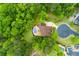 A stunning aerial view of the home nestled amongst lush greenery and mature trees at 51 Sagemont Ct, Acworth, GA 30101