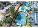 A fantastic aerial view of neighborhood tennis courts, pool and clubhouse next to ample parking and residences at 51 Sagemont Ct, Acworth, GA 30101