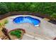 Aerial view of a kidney-shaped pool surrounded by a fence and foliage at 51 Sagemont Ct, Acworth, GA 30101