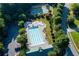 An aerial view of a sparkling community pool, splash pad, basketball court and green spaces at 51 Sagemont Ct, Acworth, GA 30101