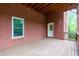 Outdoor deck with brick wall, wood ceiling, and white door at 51 Sagemont Ct, Acworth, GA 30101
