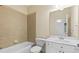 Bathroom featuring bathtub, tiled walls, sink with white cabinets, and large mirror at 51 Sagemont Ct, Acworth, GA 30101