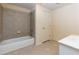 Well-lit bathroom with tiled floors, tiled walls, a tub and a sink at 51 Sagemont Ct, Acworth, GA 30101