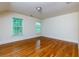 Sunlit bedroom featuring hardwood floors, neutral walls, and two large windows at 51 Sagemont Ct, Acworth, GA 30101