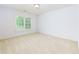 Bright bedroom with neutral walls and carpet and a large window overlooking lush greenery at 51 Sagemont Ct, Acworth, GA 30101