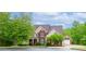 Charming brick home with a lush green lawn and mature trees, offering great curb appeal and a welcoming facade at 51 Sagemont Ct, Acworth, GA 30101