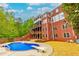 Large brick home with covered balconies and an in-ground pool at 51 Sagemont Ct, Acworth, GA 30101