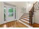 Elegant foyer with hardwood floors, a staircase, and a decorative glass front door at 51 Sagemont Ct, Acworth, GA 30101