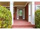 Charming front porch with brick flooring, a swing, and a stylish front door at 51 Sagemont Ct, Acworth, GA 30101
