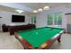 Basement game room with pool table, tv, and leather sofa at 51 Sagemont Ct, Acworth, GA 30101