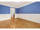 Spacious hallway showcasing classic wainscoting and hardwood flooring, leading to a glimpse of an adjoining room at 51 Sagemont Ct, Acworth, GA 30101