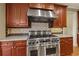 Gourmet kitchen with stainless steel range, backsplash and custom cabinetry at 51 Sagemont Ct, Acworth, GA 30101