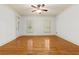 Large, sunlit living room features hardwood floors and multiple windows with plantation shutters, creating a bright space at 51 Sagemont Ct, Acworth, GA 30101
