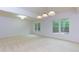 Open living room features neutral carpet, recessed lighting and large windows at 51 Sagemont Ct, Acworth, GA 30101