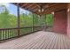Relaxing screened porch with ceiling fan, wood floors and view of lush green trees at 51 Sagemont Ct, Acworth, GA 30101