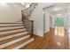 Hardwood staircase and floors with an open view to the entry hallway and windows at 51 Sagemont Ct, Acworth, GA 30101