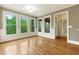 Light-filled sunroom with multiple windows overlooking green scenery, complete with hardwood floors and classic trim at 51 Sagemont Ct, Acworth, GA 30101