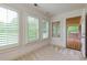 Sunroom with large windows, neutral walls, and door leading to backyard deck at 51 Sagemont Ct, Acworth, GA 30101