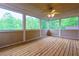 Enjoy nature in this screened sunroom with wood paneled walls and ceiling with multiple windows and wood floor at 51 Sagemont Ct, Acworth, GA 30101
