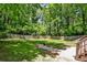 A fenced backyard offers a well-maintained lawn, landscaping and access to the upper level with steps at 1362 Briarcliff Ne Rd, Atlanta, GA 30306