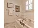 This cozy bathroom boasts a luxurious soaking tub with marble surround, and a tiled floor and shower at 1362 Briarcliff Ne Rd, Atlanta, GA 30306