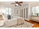 Bright bedroom with hardwood floors features a large bed, shuttered windows and a ceiling fan at 1362 Briarcliff Ne Rd, Atlanta, GA 30306