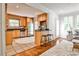 Open concept kitchen with stainless appliances, wood cabinetry, and view into the adjacent living room at 1362 Briarcliff Ne Rd, Atlanta, GA 30306