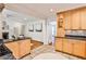 Cozy kitchen boasts granite countertops, wooden cabinetry and tiled floor leading into living area at 1362 Briarcliff Ne Rd, Atlanta, GA 30306