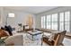 Bright and airy living room with hardwood floors, large windows, and stylish contemporary furniture at 1362 Briarcliff Ne Rd, Atlanta, GA 30306