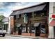 Attractive restaurant exterior with dark wood paneling, black awning, and well-lit entrance at 1362 Briarcliff Ne Rd, Atlanta, GA 30306