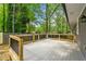New deck with wood railing, providing a relaxing outdoor space with views of the wooded backyard at 2663 Lowell Dr, Morrow, GA 30260