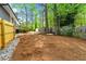 Expansive backyard with lush trees and new fence, offering privacy and space for outdoor activities at 2663 Lowell Dr, Morrow, GA 30260