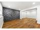 Finished basement featuring wood-look floors and a stone accent wall at 2663 Lowell Dr, Morrow, GA 30260