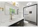 Elegant bathroom featuring marble countertops, modern fixtures, and a glass-enclosed shower at 2663 Lowell Dr, Morrow, GA 30260