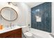 Stylish bathroom features a tub with blue herringbone tile and a modern wood vanity at 2663 Lowell Dr, Morrow, GA 30260