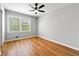 Bright bedroom with wood floors, a ceiling fan, and a large window with natural light at 2663 Lowell Dr, Morrow, GA 30260