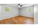 Inviting bedroom with wood floors, ceiling fan, and bright natural light from two windows at 2663 Lowell Dr, Morrow, GA 30260
