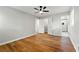 Spacious bedroom with wood floors, a ceiling fan, and a view into the en suite bathroom at 2663 Lowell Dr, Morrow, GA 30260