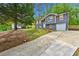 Inviting home with gray siding, shutters, white trim, and an attached garage at 2663 Lowell Dr, Morrow, GA 30260