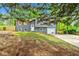 Charming home with gray siding, white trim, shutters, and a well-maintained lawn at 2663 Lowell Dr, Morrow, GA 30260