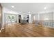 Open-concept living room with hardwood floors, and an open floorplan to the kitchen at 2663 Lowell Dr, Morrow, GA 30260