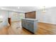 Spacious living room area with wood floors, kitchen island, and modern lighting at 2663 Lowell Dr, Morrow, GA 30260