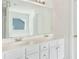 Bright bathroom featuring a double vanity with white countertops and cabinetry and an oversized mirror at 3060 Elmwood Ct, College Park, GA 30349