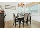 Cozy dining room with chandelier lighting and a view of the backyard through the windows at 3060 Elmwood Ct, College Park, GA 30349