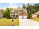 Beautiful two-story home with a brick and siding exterior, two-car garage, and front lawn at 3060 Elmwood Ct, College Park, GA 30349