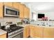 Close-up of kitchen featuring stainless steel appliances and a view of the living room at 3060 Elmwood Ct, College Park, GA 30349