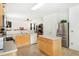 Well-lit kitchen with stainless steel appliances, tiled flooring, and a center island at 3060 Elmwood Ct, College Park, GA 30349