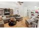 Open living room view showcasing hardwood floors, sofa, a bookshelf, and bar seating at 3060 Elmwood Ct, College Park, GA 30349